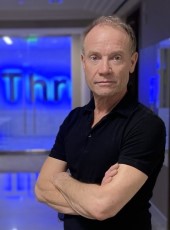 Photo of Lee Harrison in front of Thru sign in Thru headquarters in Irving, TX